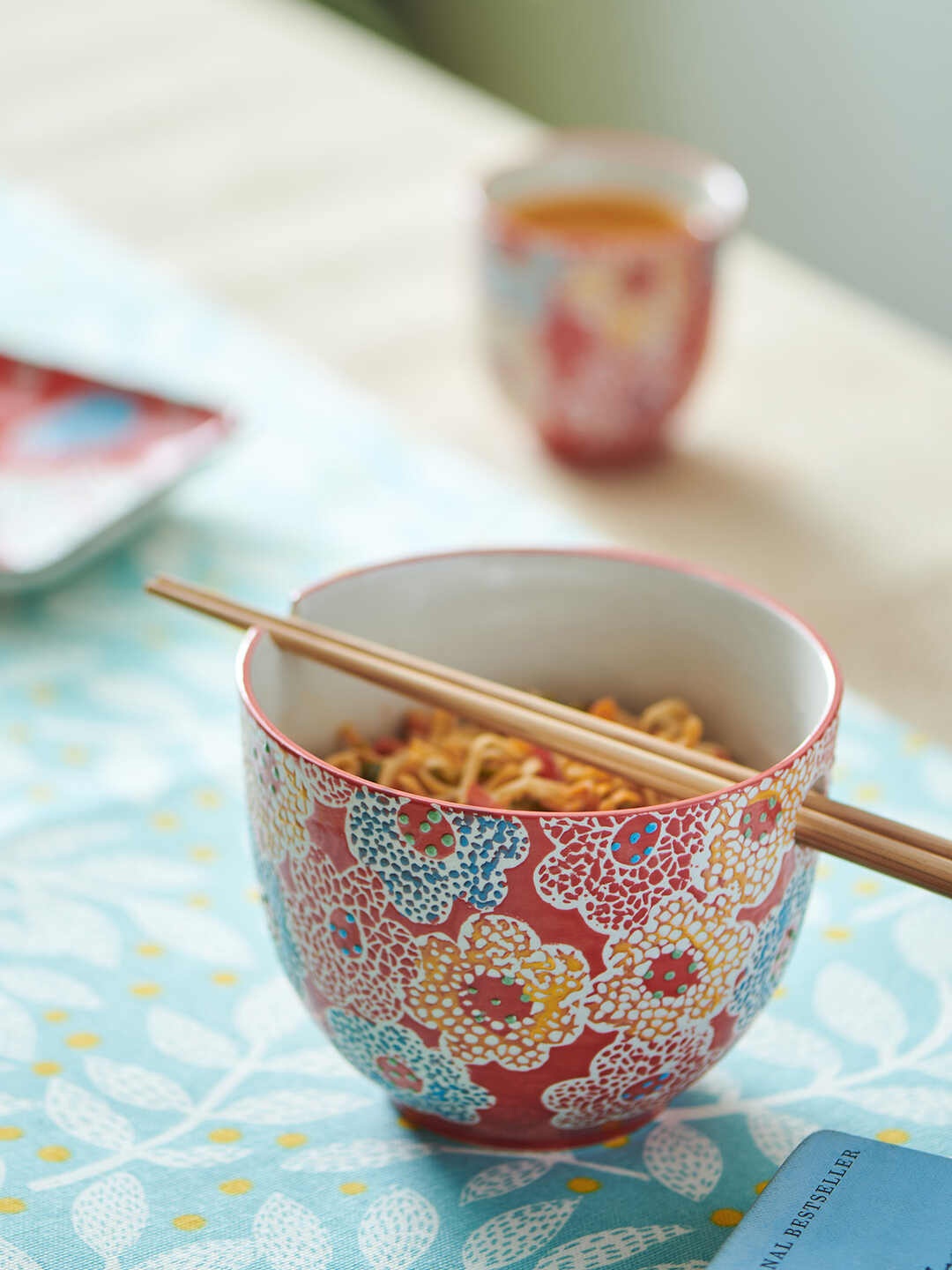 Chumbak Flowerbeds Mosaic Red & Blue Floral Printed Ceramic Glossy Bowl with Chopsticks
Chumbak Flowerbeds Mosaic Red & Blue Floral Printed Ceramic Glossy Bowl with Chopsticks