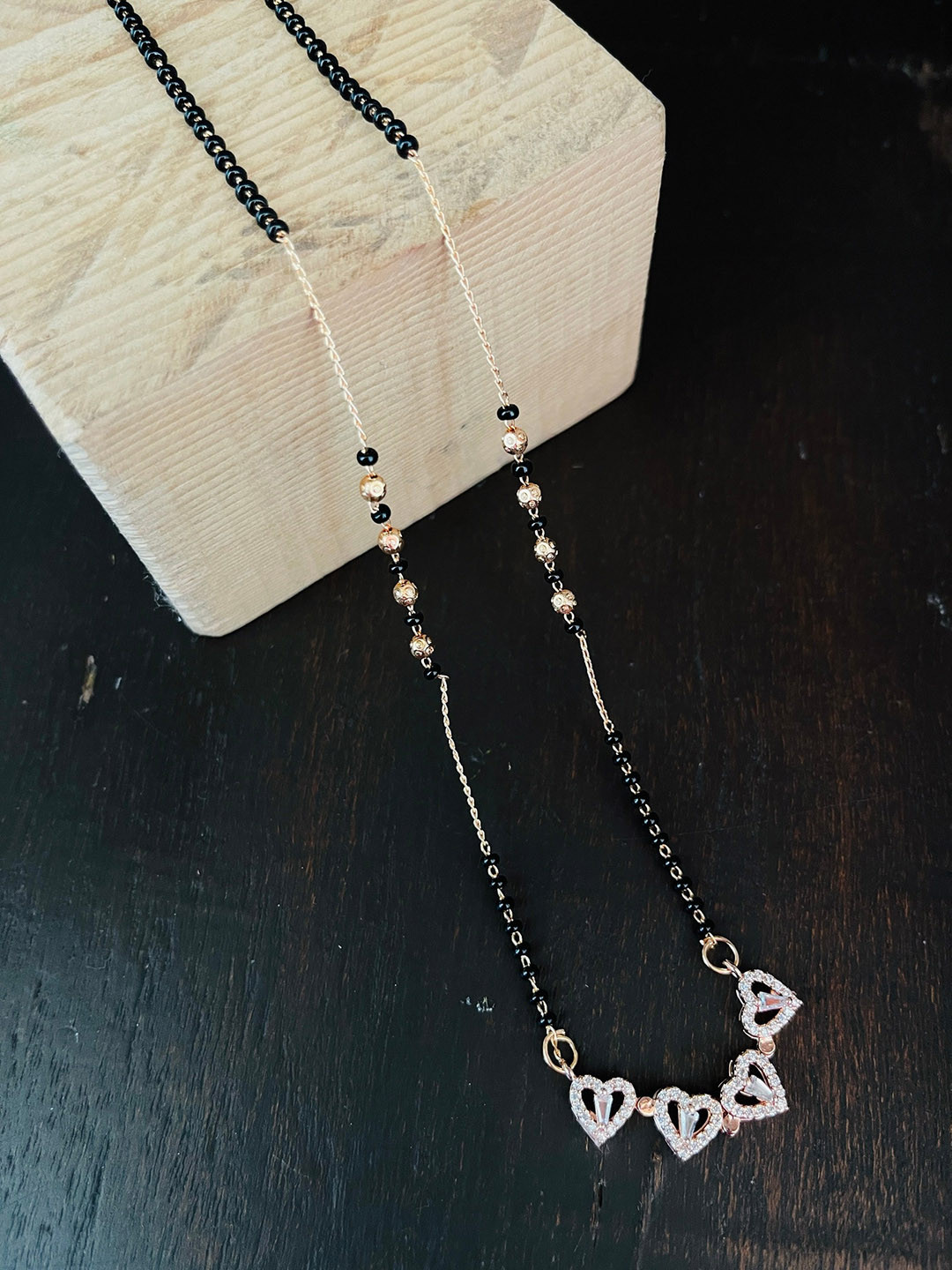The Opal Factory Gold-Plated Beaded & AD Studded Magnetic Heart Flower Mangalsutra, Black
The Opal Factory Gold-Plated Beaded & AD Studded Magnetic Heart Flower Mangalsutra, Black
