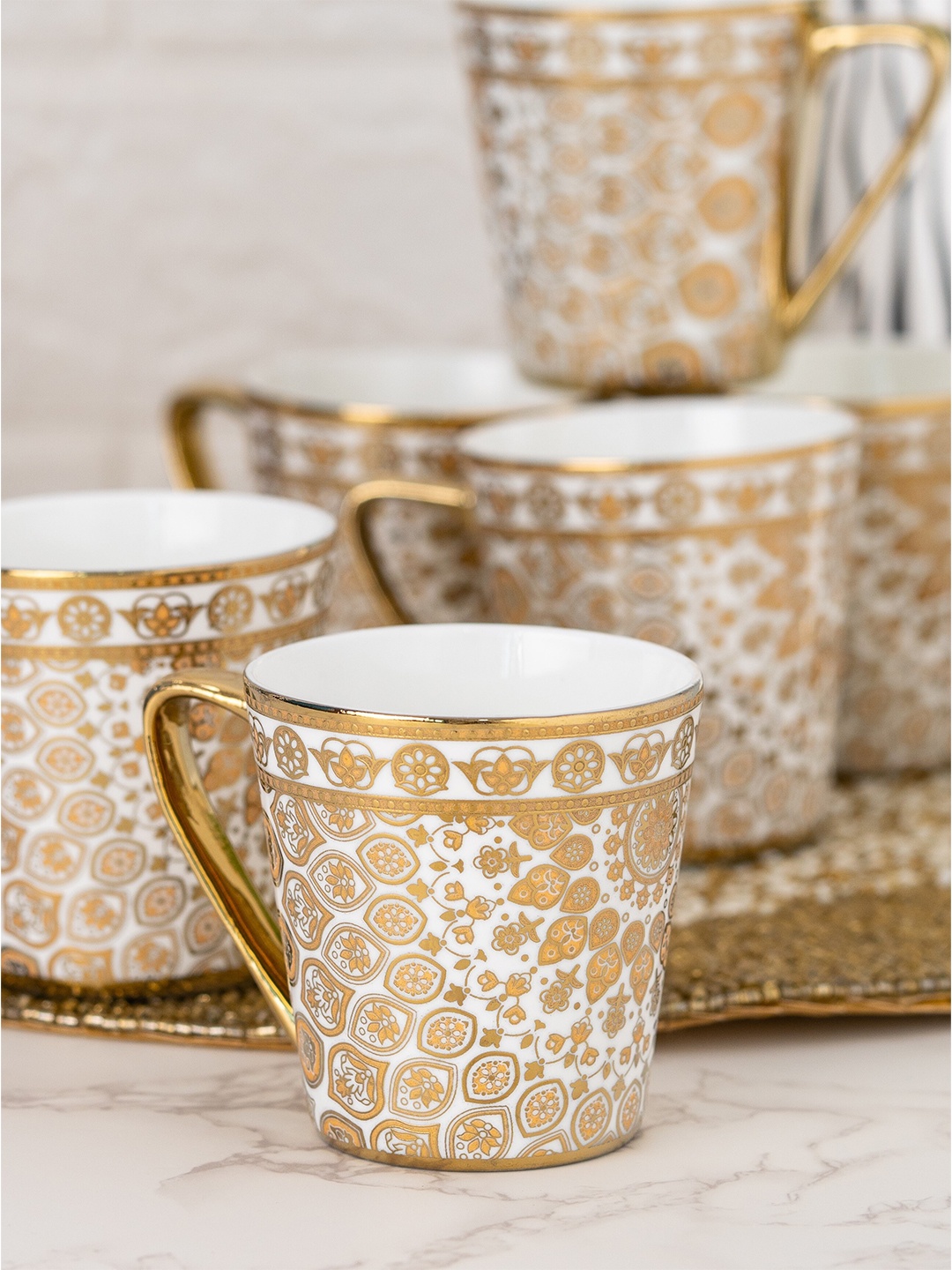 CLAY CRAFT White & Gold-Toned 6 Pcs Ethnic Motif Printed Ceramic Glossy Cups 180 ml Each
CLAY CRAFT White & Gold-Toned 6 Pcs Ethnic Motif Printed Ceramic Glossy Cups 180 ml Each