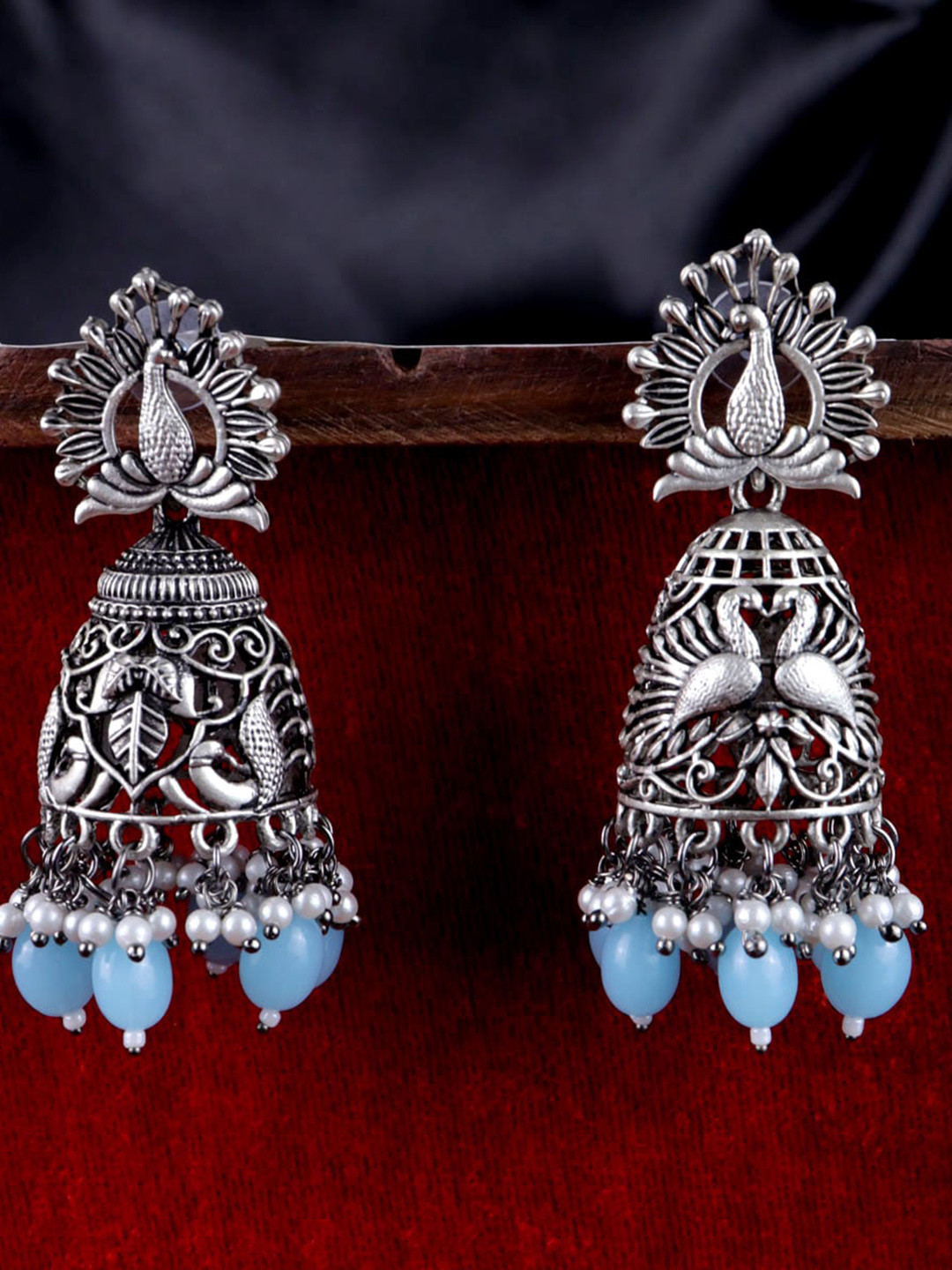 VAGHBHATT Silver-Plated Oxidized German Silver Peacock Shaped Jhumkas, Blue
VAGHBHATT Silver-Plated Oxidized German Silver Peacock Shaped Jhumkas, Blue