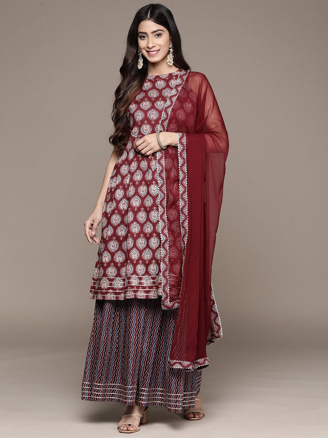 Ishin Women Maroon Ethnic Motifs Printed Pure Cotton Kurta with Sharara & With Dupatta
Ishin Women Maroon Ethnic Motifs Printed Pure Cotton Kurta with Sharara & With Dupatta