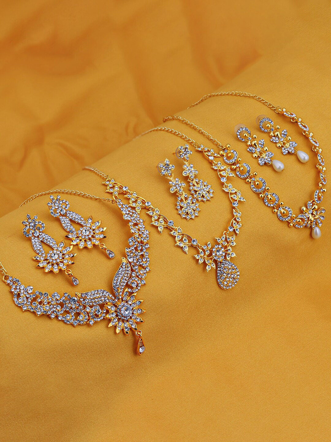 Sukkhi Set Of 3 Gold-Plated AD Stone-Studded Jewellery Set
Sukkhi Set Of 3 Gold-Plated AD Stone-Studded Jewellery Set