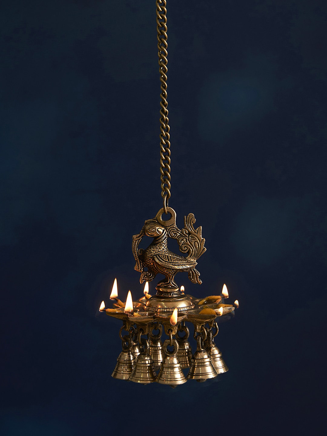DecorTwist Brass Antique Peacock Shaped Hanging Diyas with Bells for Pooja Room, Gold
DecorTwist Brass Antique Peacock Shaped Hanging Diyas with Bells for Pooja Room, Gold