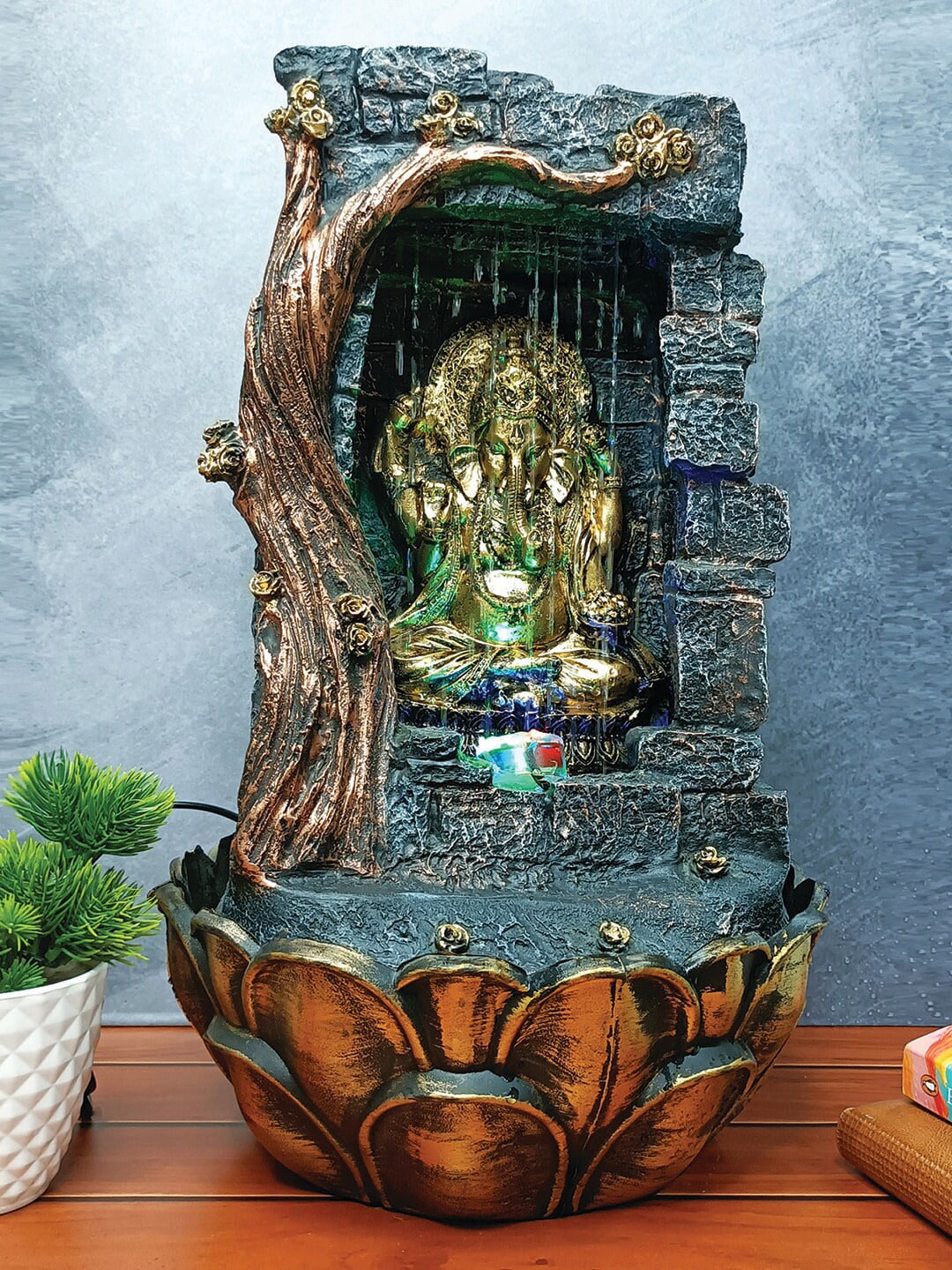 WENS Grey & Gold-Toned Lord Ganesha Indoor Polyresin Water Fall Fountain With Led Lights
WENS Grey & Gold-Toned Lord Ganesha Indoor Polyresin Water Fall Fountain With Led Lights