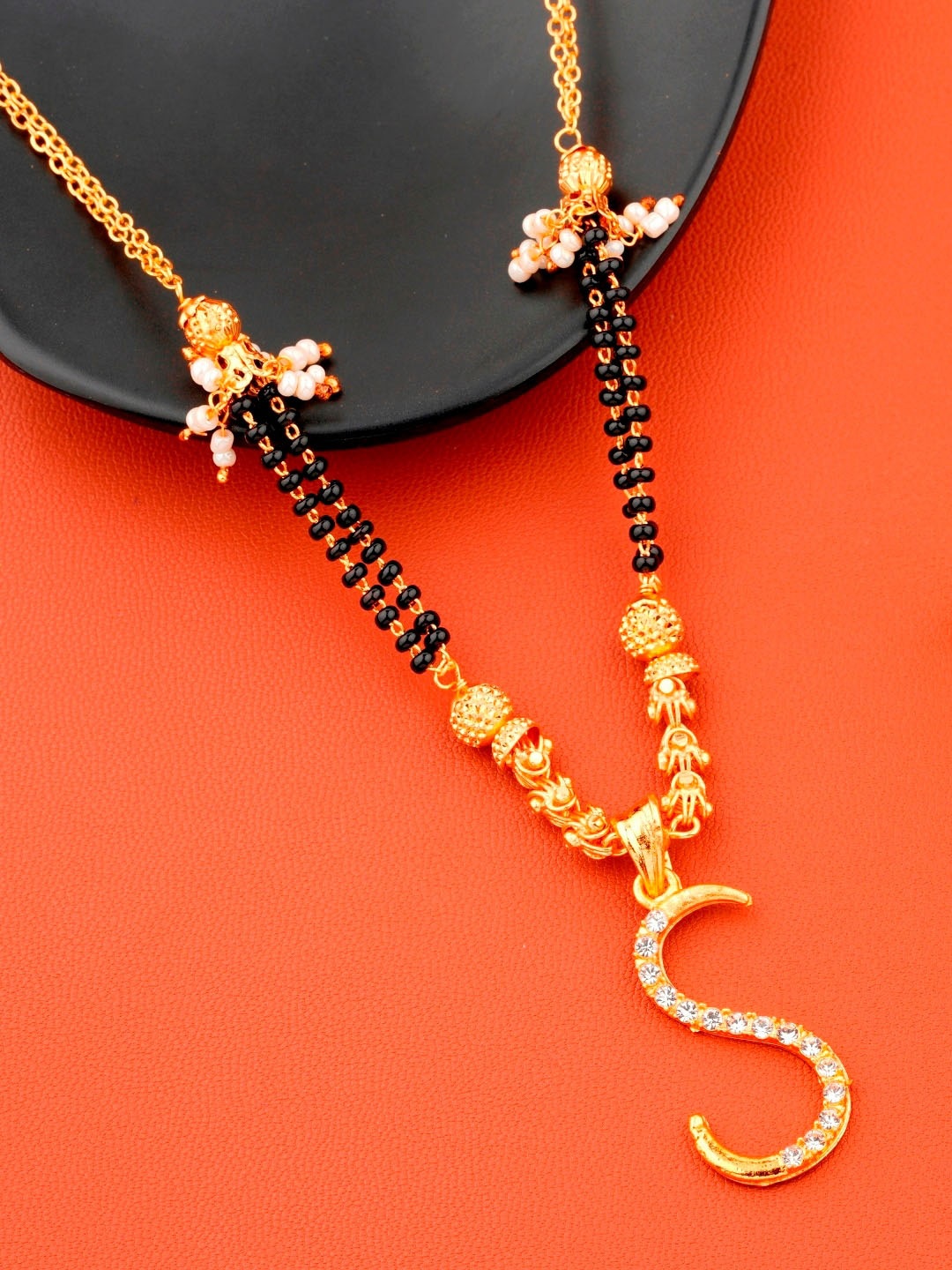 JEWEL WORLD Gold-Plated & Black Stone-Studded & Beaded Alphabet S Charm Short Mangalsutra
JEWEL WORLD Gold-Plated & Black Stone-Studded & Beaded Alphabet S Charm Short Mangalsutra