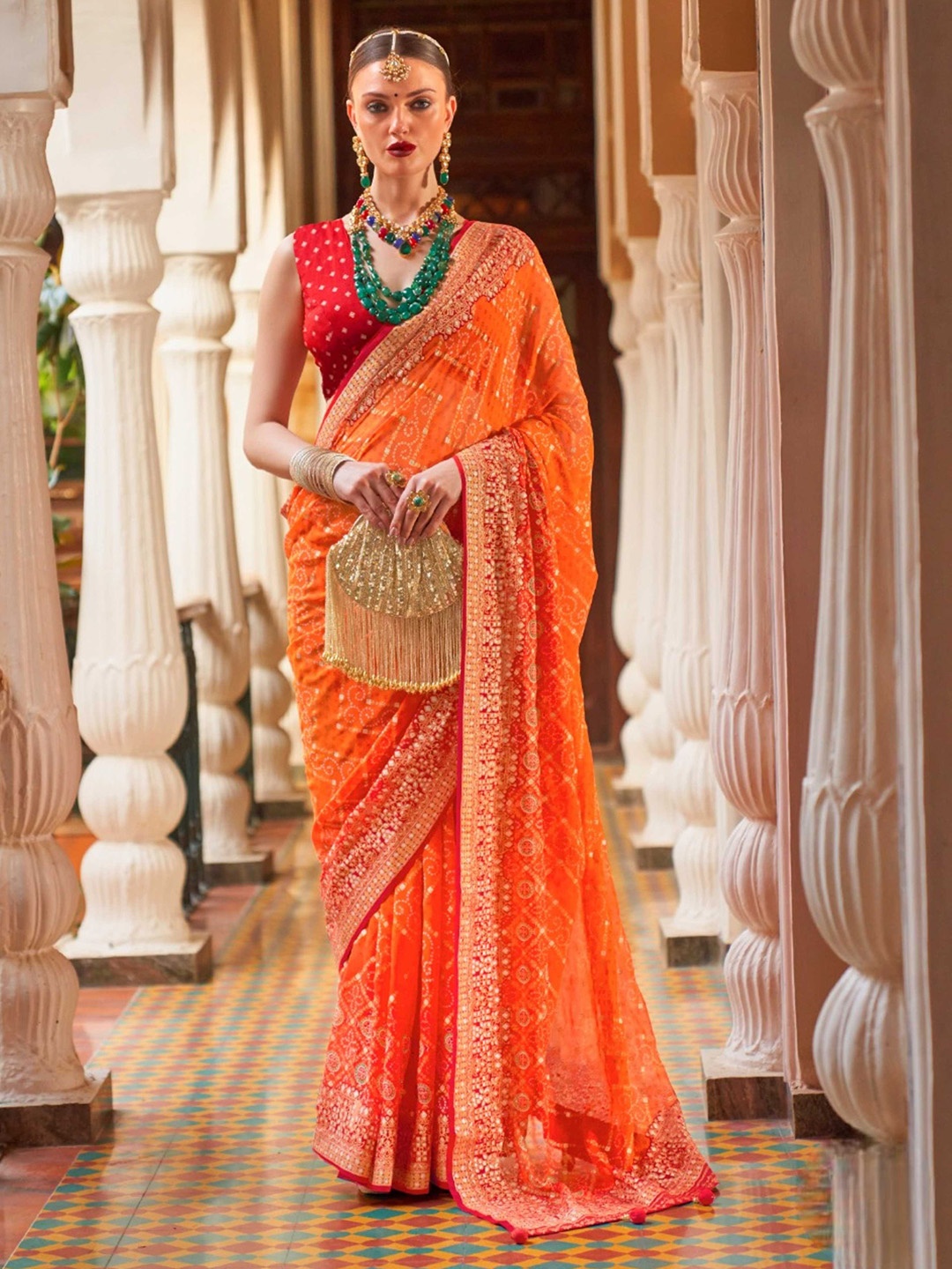 Mitera Orange & Red Ethnic Motifs Printed Embellished Pure Georgette Leheriya Saree
Mitera Orange & Red Ethnic Motifs Printed Embellished Pure Georgette Leheriya Saree