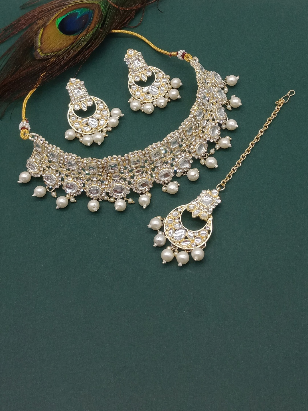 AASHISH IMITATION Gold-Plated & Kundan Studded Necklace & Earrings With Maangtika
AASHISH IMITATION Gold-Plated & Kundan Studded Necklace & Earrings With Maangtika