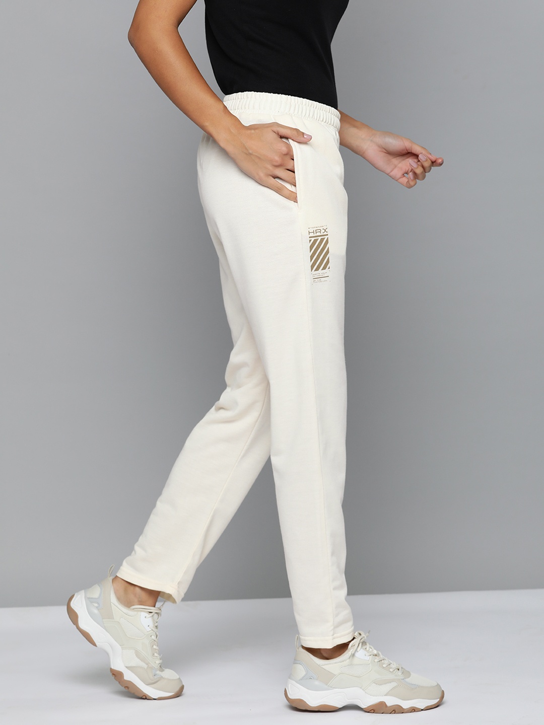 HRX by Hrithik Roshan Women Solid Minimal Brand Print Lifestyle Track Pants, Off white
HRX by Hrithik Roshan Women Solid Minimal Brand Print Lifestyle Track Pants, Off white