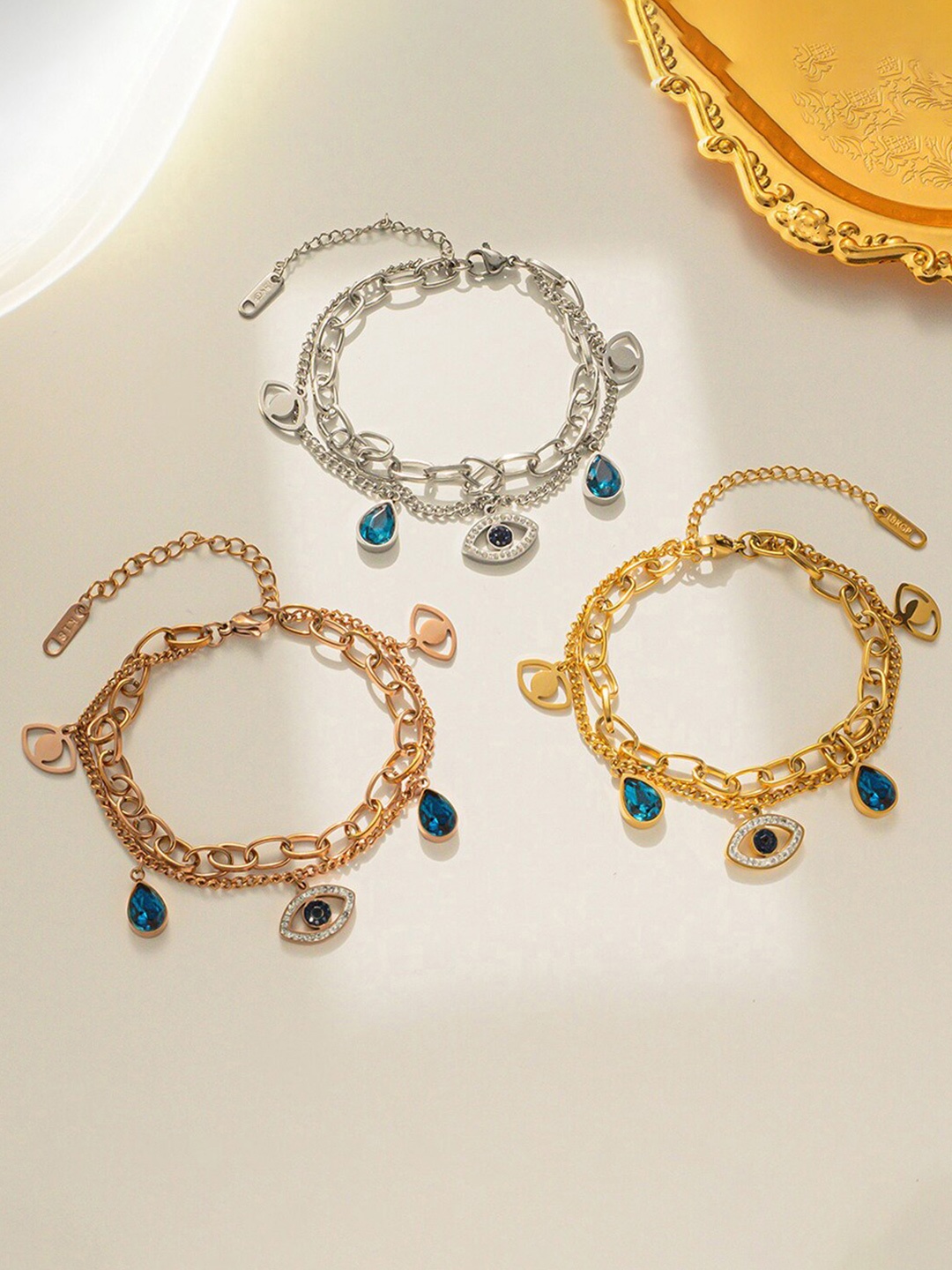 Jewels Galaxy Pack Of 3 Gold Plated Stone Studded Evil Eye Charm Bracelets, Rose gold
Jewels Galaxy Pack Of 3 Gold Plated Stone Studded Evil Eye Charm Bracelets, Rose gold