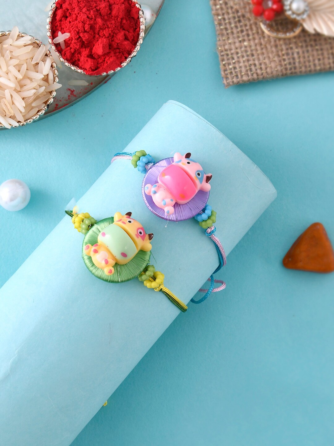 Aapno Rajasthan Set Of 2 Resham Based Cow Toy Rakh With Roli Rice & Greeting Card, Purple
Aapno Rajasthan Set Of 2 Resham Based Cow Toy Rakh With Roli Rice & Greeting Card, Purple