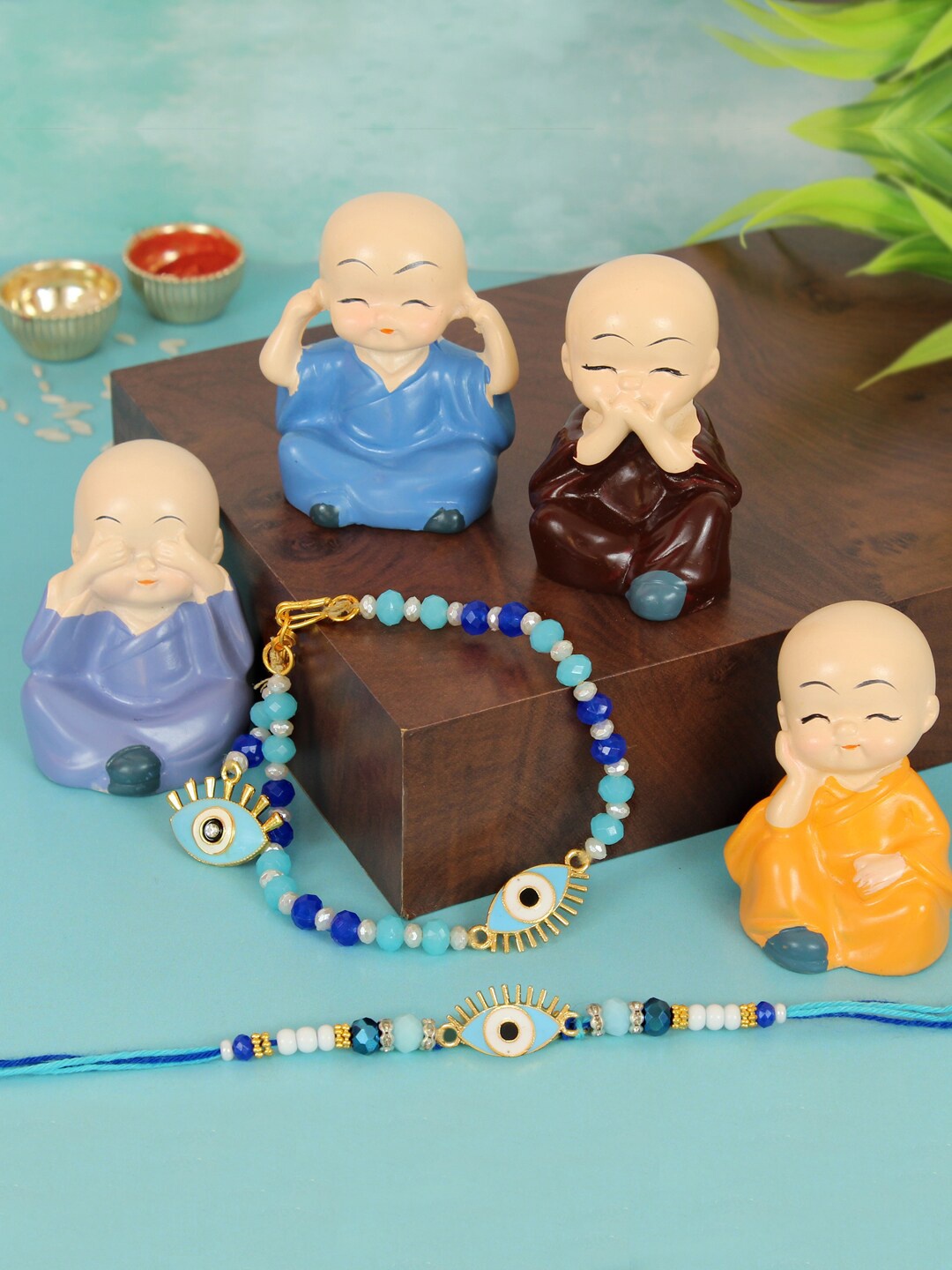 TIED RIBBONS Set Of 2 Bhaiya & Bhabhi Lumba Rakhi Gift Set With 4 Buddha Monk Idols, Blue
TIED RIBBONS Set Of 2 Bhaiya & Bhabhi Lumba Rakhi Gift Set With 4 Buddha Monk Idols, Blue