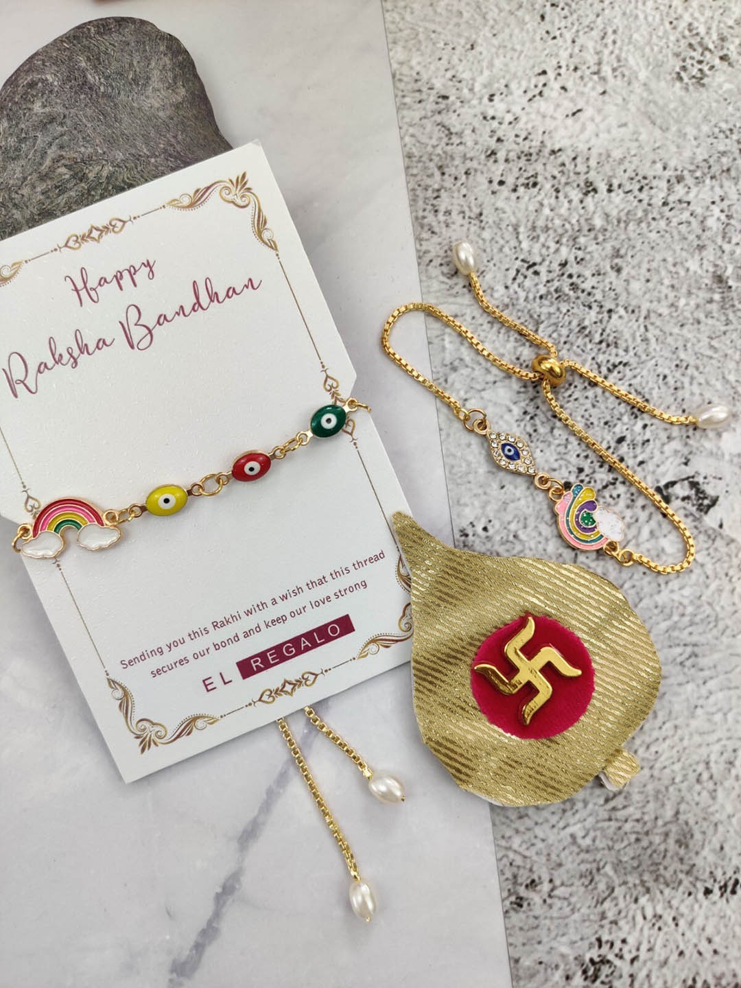 EL REGALO Men Set Of 2 Evil Eye & Rainbow Charm Rakhi With Candle & Greeting Card, Gold
EL REGALO Men Set Of 2 Evil Eye & Rainbow Charm Rakhi With Candle & Greeting Card, Gold