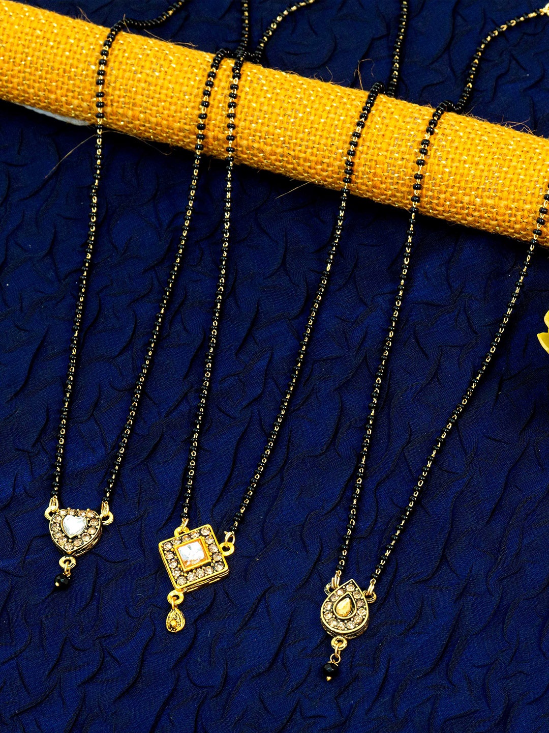 Ramdev Art Fashion Jwellery Set Of 3 Gold-Plated Stone-Studded & Beaded Mangalsutras
Ramdev Art Fashion Jwellery Set Of 3 Gold-Plated Stone-Studded & Beaded Mangalsutras