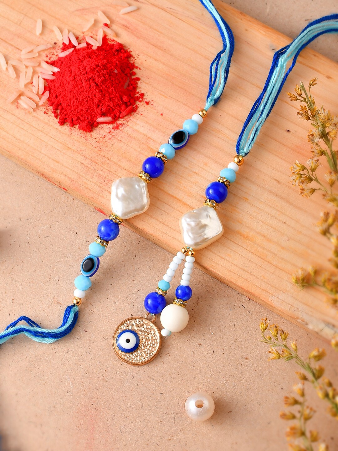 Aapno Rajasthan Unisex Set Of 2 Evil Eye Beaded Rakhis With Roli Rice & Greeting, Blue
Aapno Rajasthan Unisex Set Of 2 Evil Eye Beaded Rakhis With Roli Rice & Greeting, Blue