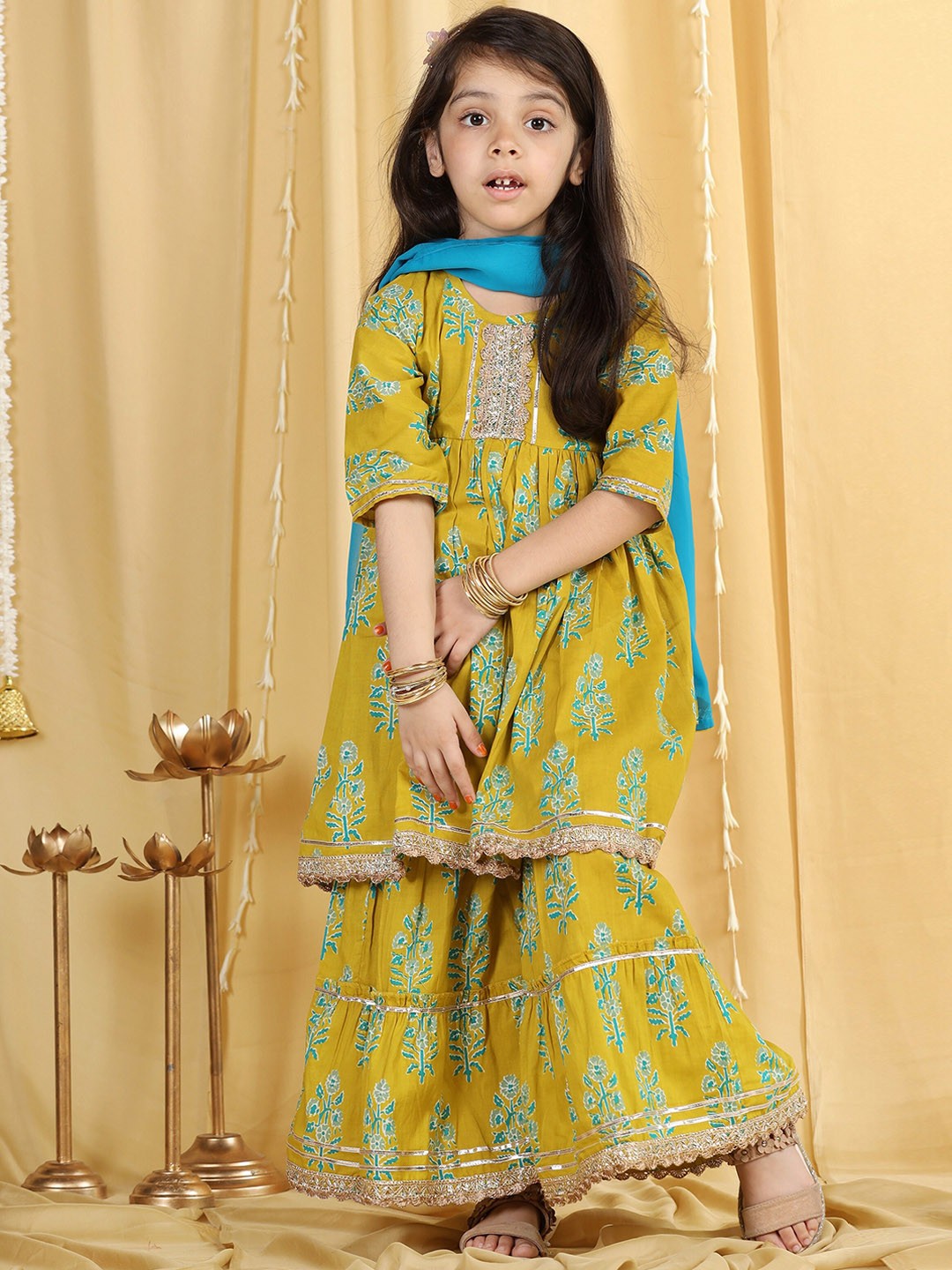 Aj DEZInES Girls Green & Blue Floral Printed Empire Cotton Kurta With Sharara & Dupatta
Aj DEZInES Girls Green & Blue Floral Printed Empire Cotton Kurta With Sharara & Dupatta