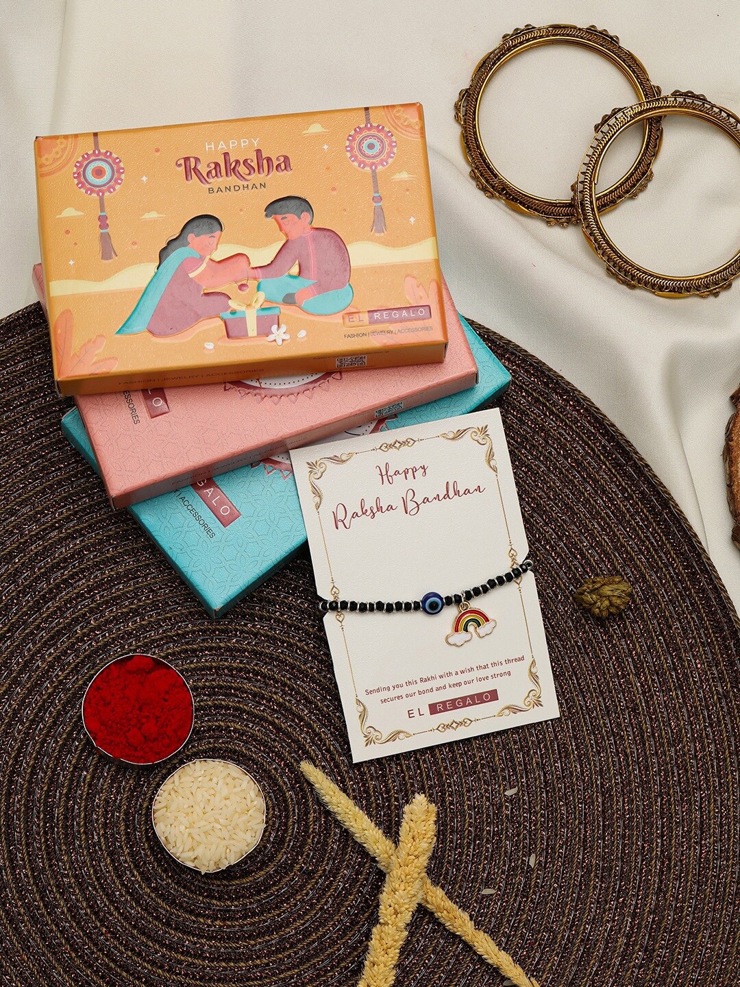 EL REGALO Kids Evil Eye & Rainbow Charm Design Rakhi With Roli Chawl & Card Gift Set Box, Silver
EL REGALO Kids Evil Eye & Rainbow Charm Design Rakhi With Roli Chawl & Card Gift Set Box, Silver