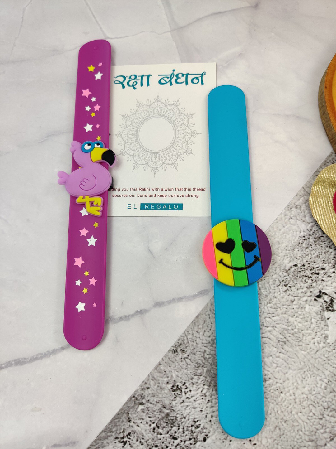 EL REGALO Kids Set Of 2 Dinosaur Design Slap Band Rakhi With Roli Chawl & Card Gift Set, Purple
EL REGALO Kids Set Of 2 Dinosaur Design Slap Band Rakhi With Roli Chawl & Card Gift Set, Purple