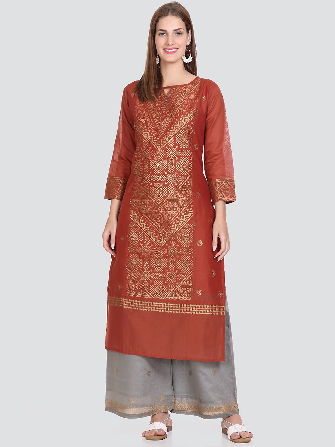 Elthia Key Hole Neck Ethnic Motif Printed Beads And Stones Pure Silk Kurta with Palazzos, Rust
Elthia Key Hole Neck Ethnic Motif Printed Beads And Stones Pure Silk Kurta with Palazzos, Rust