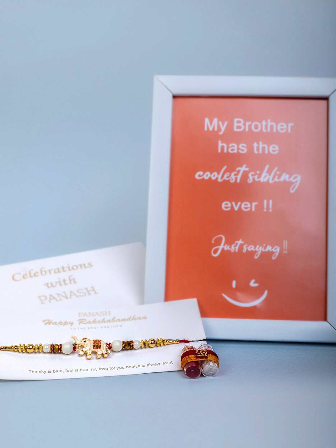 PANASH Gold-Plated Elephant Charm Rakhi With Roli Chawal & Photo Frame Gift Set
PANASH Gold-Plated Elephant Charm Rakhi With Roli Chawal & Photo Frame Gift Set
