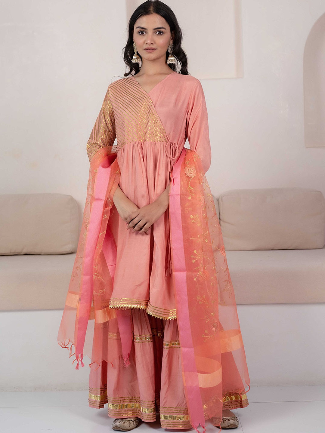 Sangria Peach-Coloured Striped V-Neck Angrakha Gotta Patti Kurta With Sharara & Dupatta
Sangria Peach-Coloured Striped V-Neck Angrakha Gotta Patti Kurta With Sharara & Dupatta
