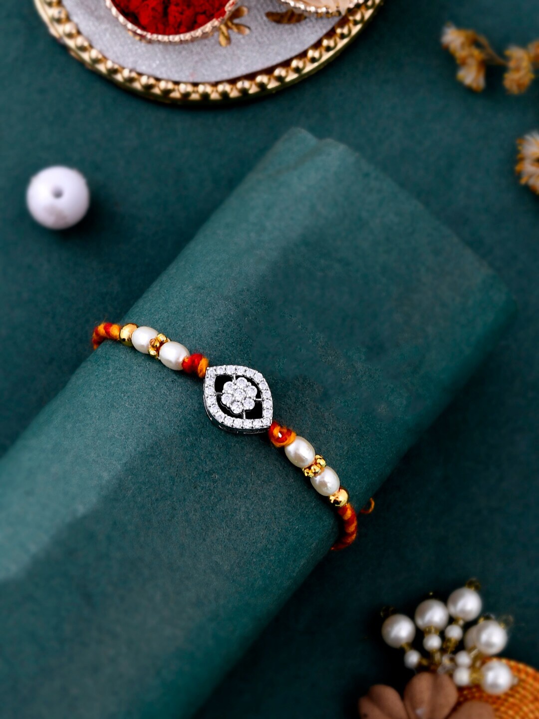Aapno Rajasthan Floral American Diamond-Studded Silver Rakhi With Roli Chawal & Card
Aapno Rajasthan Floral American Diamond-Studded Silver Rakhi With Roli Chawal & Card