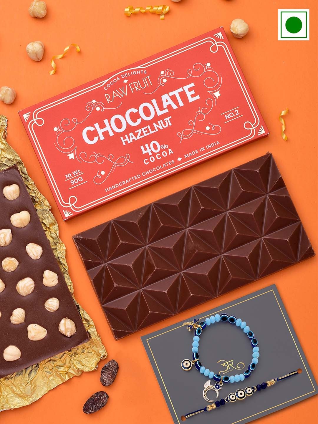 RawFruit Set Of 2 Evil Eye Beaded Rakhi With Hazelnut Chocolate Bar Gift Set-90gms, Orange
RawFruit Set Of 2 Evil Eye Beaded Rakhi With Hazelnut Chocolate Bar Gift Set-90gms, Orange