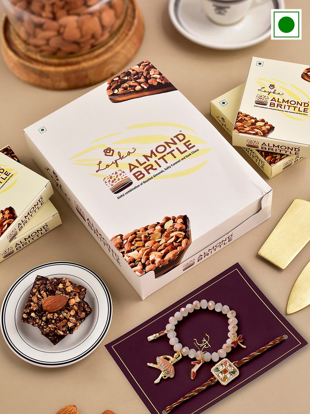 Hyperfoods Set Of 2 Stone-Studded Rakhis With Loyka Almond Brittle Chocolate Set, White
Hyperfoods Set Of 2 Stone-Studded Rakhis With Loyka Almond Brittle Chocolate Set, White
