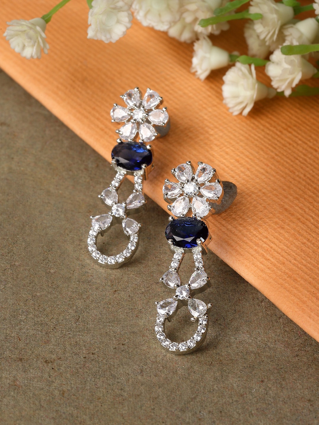 ZENEME Rhodium Plated Floral Shaped American Diamond Studded Drop Earrings, Navy blue
ZENEME Rhodium Plated Floral Shaped American Diamond Studded Drop Earrings, Navy blue