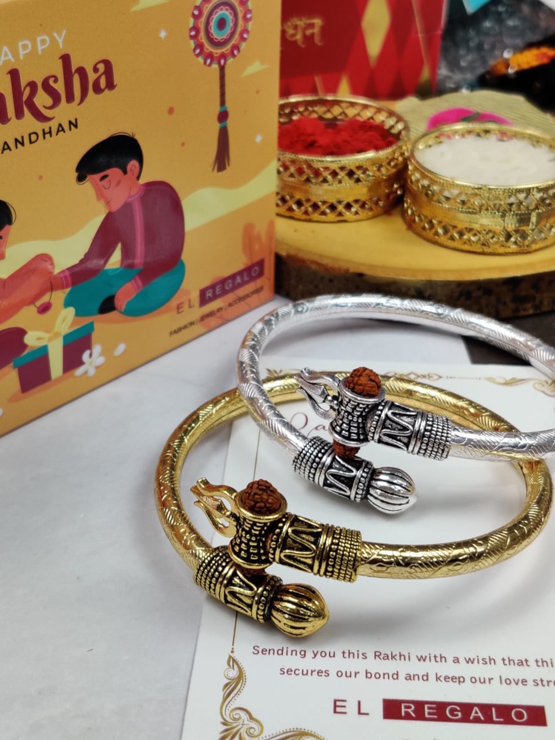EL REGALO Bhaiya Bhabhi Set Of 2 Kada Om Rakhi Gift Combo With Roli Chawal Card, Gold
EL REGALO Bhaiya Bhabhi Set Of 2 Kada Om Rakhi Gift Combo With Roli Chawal Card, Gold