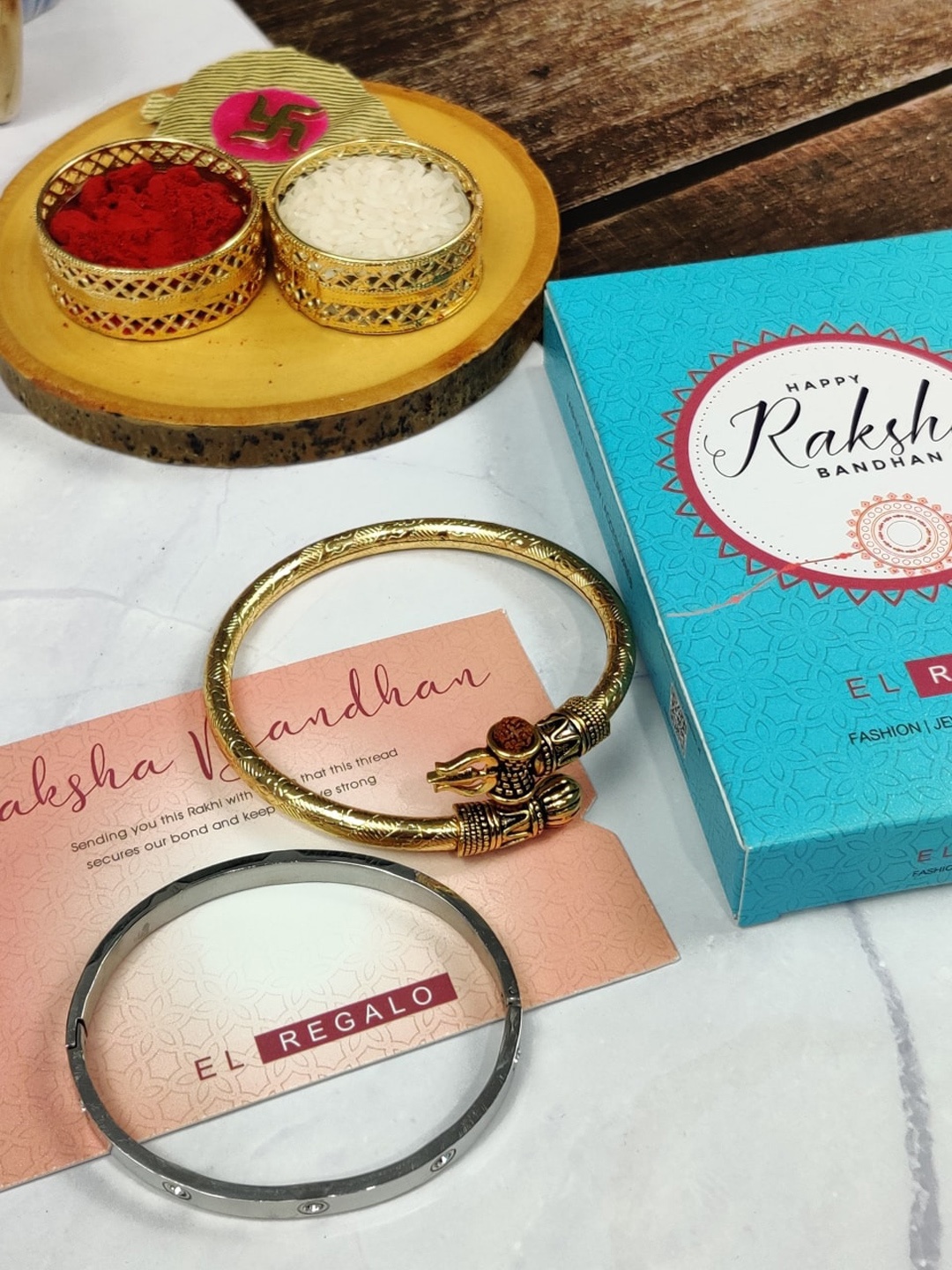 EL REGALO Bhaiya Bhabhi Set Of 2 Stone-Studded Kada Stainless Steel Rakhi With Roli Chawal Card, Gold
EL REGALO Bhaiya Bhabhi Set Of 2 Stone-Studded Kada Stainless Steel Rakhi With Roli Chawal Card, Gold