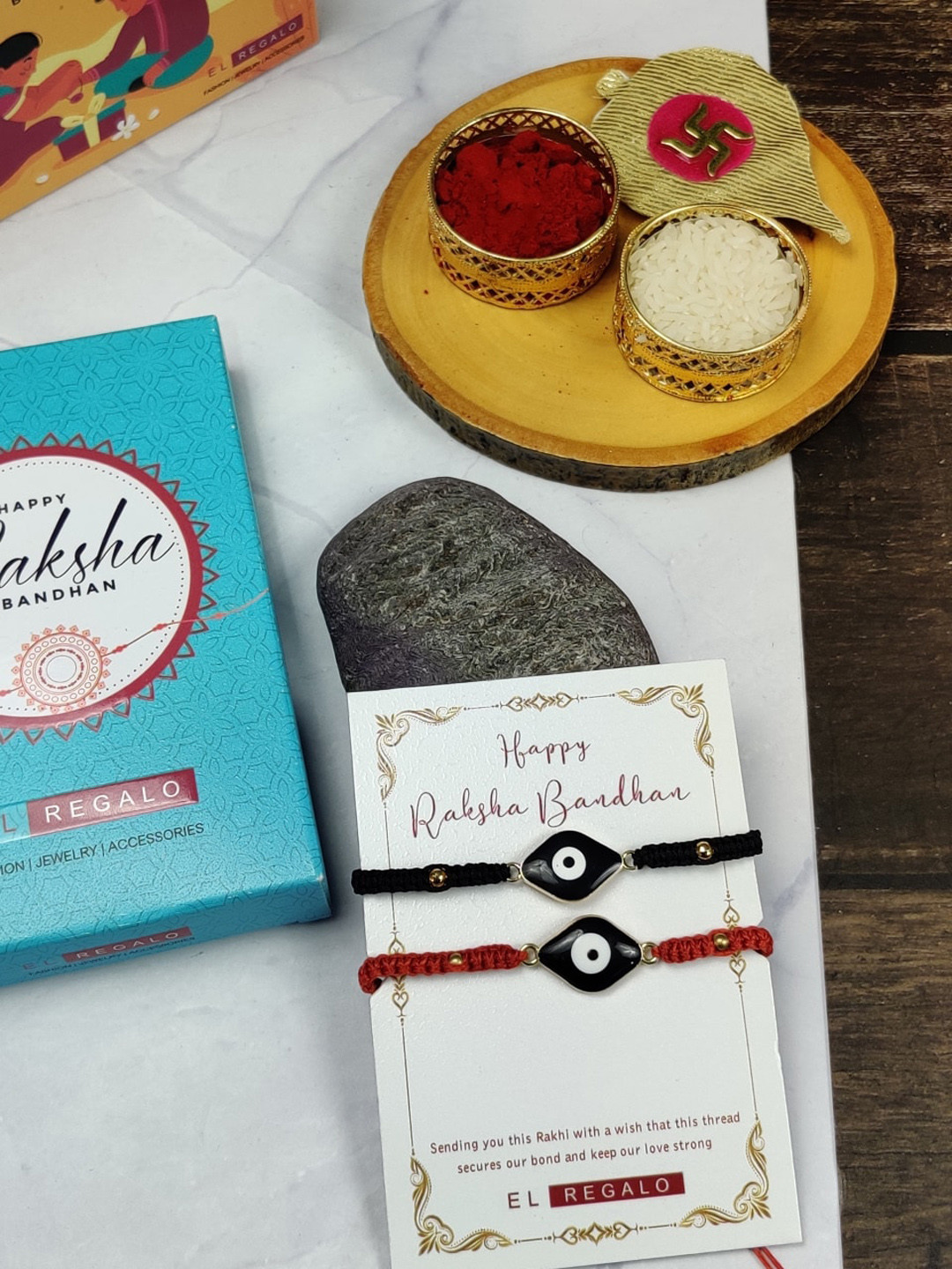 EL REGALO Bhaiya Bhabhi Set Of 2 Evil Eye Charm Rakhi Combo Roli With Chawal, Black 
EL REGALO Bhaiya Bhabhi Set Of 2 Evil Eye Charm Rakhi Combo Roli With Chawal, Black