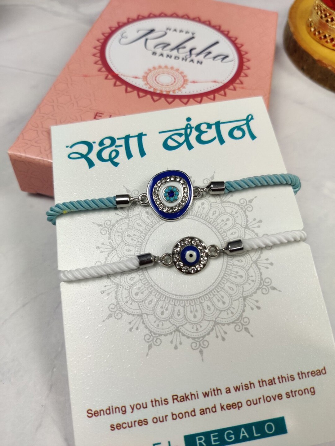 EL REGALO Bhaiya Bhabhi Set Of 2 Evil Eye Rakhi Combo With Roli Chawal and Card, Silver
EL REGALO Bhaiya Bhabhi Set Of 2 Evil Eye Rakhi Combo With Roli Chawal and Card, Silver