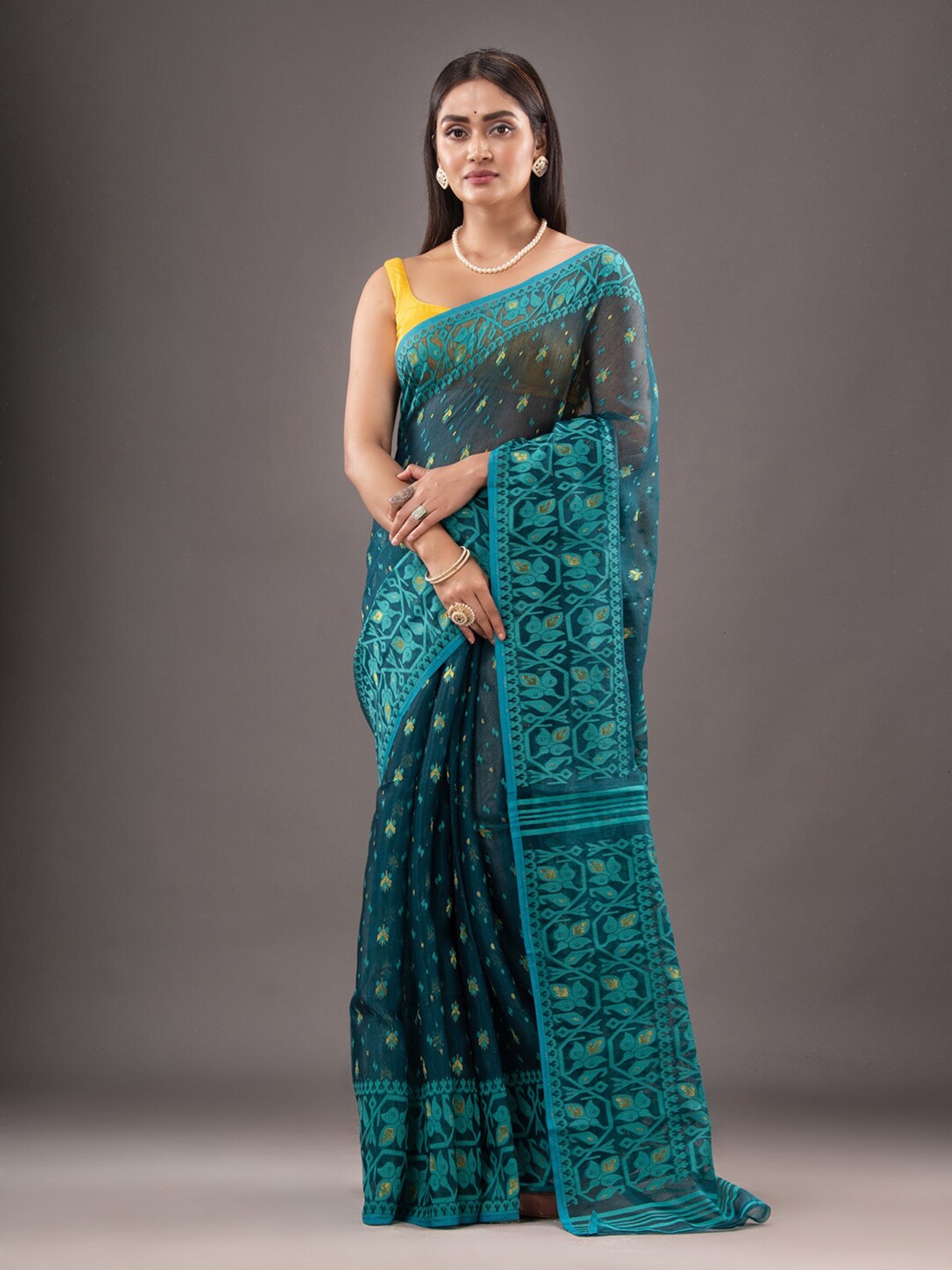 Mitera Teal & Gold-Toned Ethnic Motif Woven Design Zari Silk Cotton Jamdani Saree
Mitera Teal & Gold-Toned Ethnic Motif Woven Design Zari Silk Cotton Jamdani Saree
