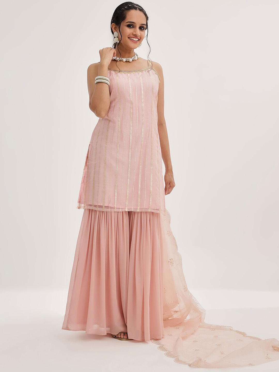 Varanga Peach Striped Shoulder Straps Embroidered Empire Kurta with Sharara & With Dupatta
Varanga Peach Striped Shoulder Straps Embroidered Empire Kurta with Sharara & With Dupatta