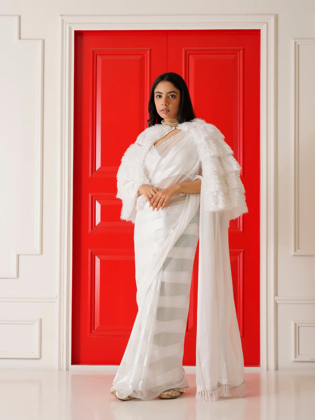 Tikhi Imli White Striped Saree With Fur Cape 
Tikhi Imli White Striped Saree With Fur Cape