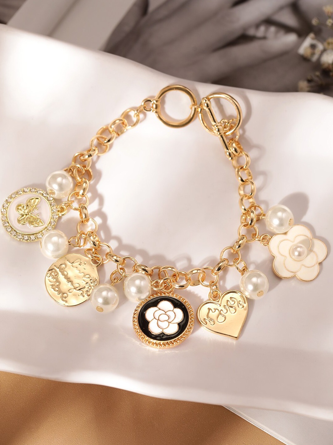 Rubans Voguish 22K Gold Plated StainlessSteel TranishFree Waterproof Pearl Charm Bracelet
Rubans Voguish 22K Gold Plated StainlessSteel TranishFree Waterproof Pearl Charm Bracelet