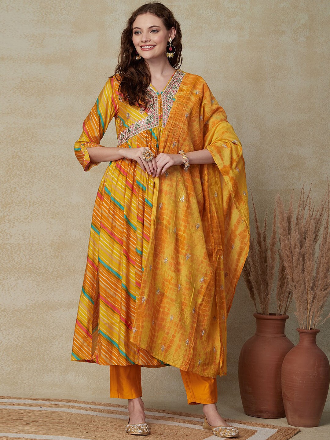 FASHOR Leheriya Printed Mirror Work Anarkali Kurta with Trousers & With Dupatta, Yellow
FASHOR Leheriya Printed Mirror Work Anarkali Kurta with Trousers & With Dupatta, Yellow