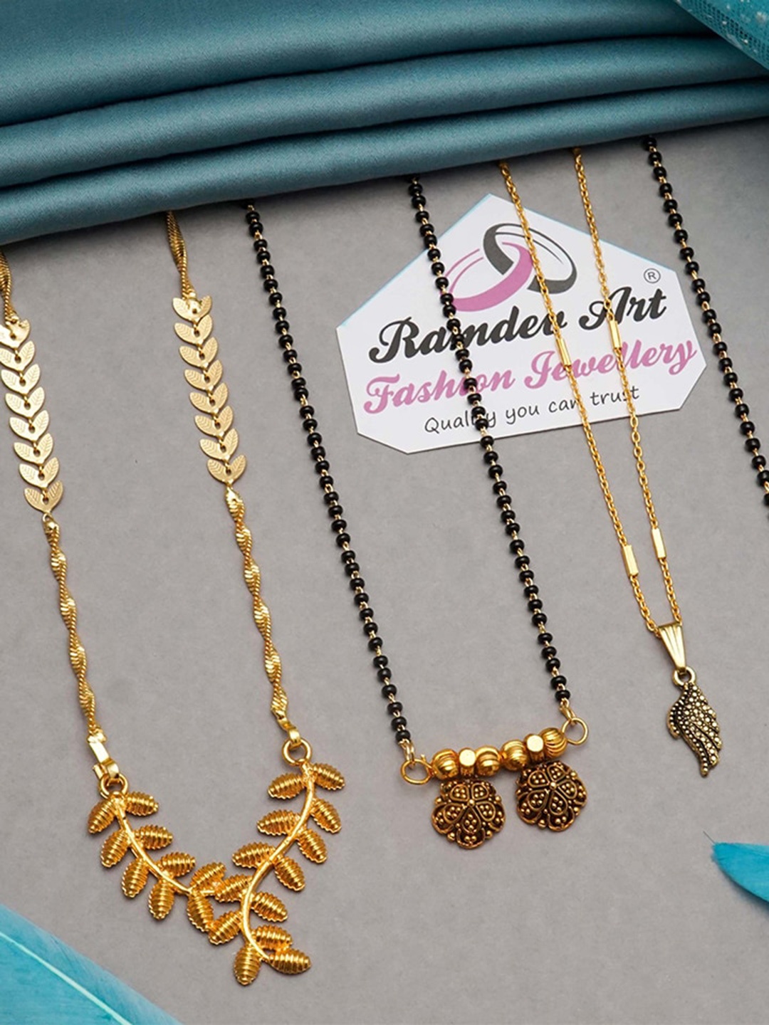 Ramdev Art Fashion Jwellery Pack Of 4 Gold Plated Stone Studded & Beaded Mangalsutras
Ramdev Art Fashion Jwellery Pack Of 4 Gold Plated Stone Studded & Beaded Mangalsutras