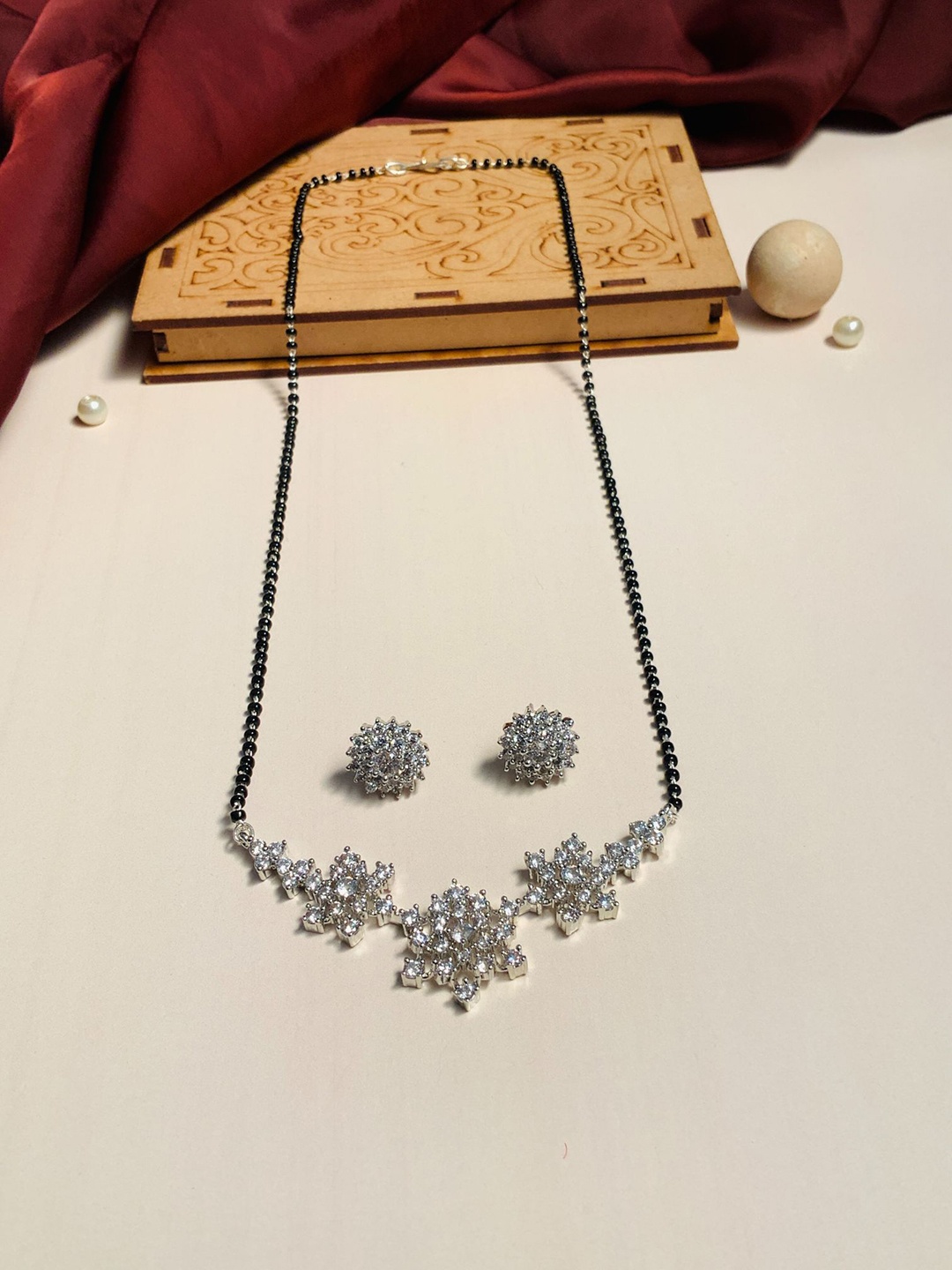 ABDESIGNS Set Of 2 Silver-Plated AD Studded Mangalsutra With Earrings
ABDESIGNS Set Of 2 Silver-Plated AD Studded Mangalsutra With Earrings