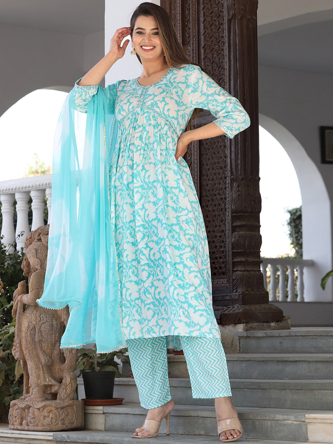 SINGNI Floral Printed Mirror Work Empire A-Line Kurta With Trousers & Dupatta, Blue
SINGNI Floral Printed Mirror Work Empire A-Line Kurta With Trousers & Dupatta, Blue