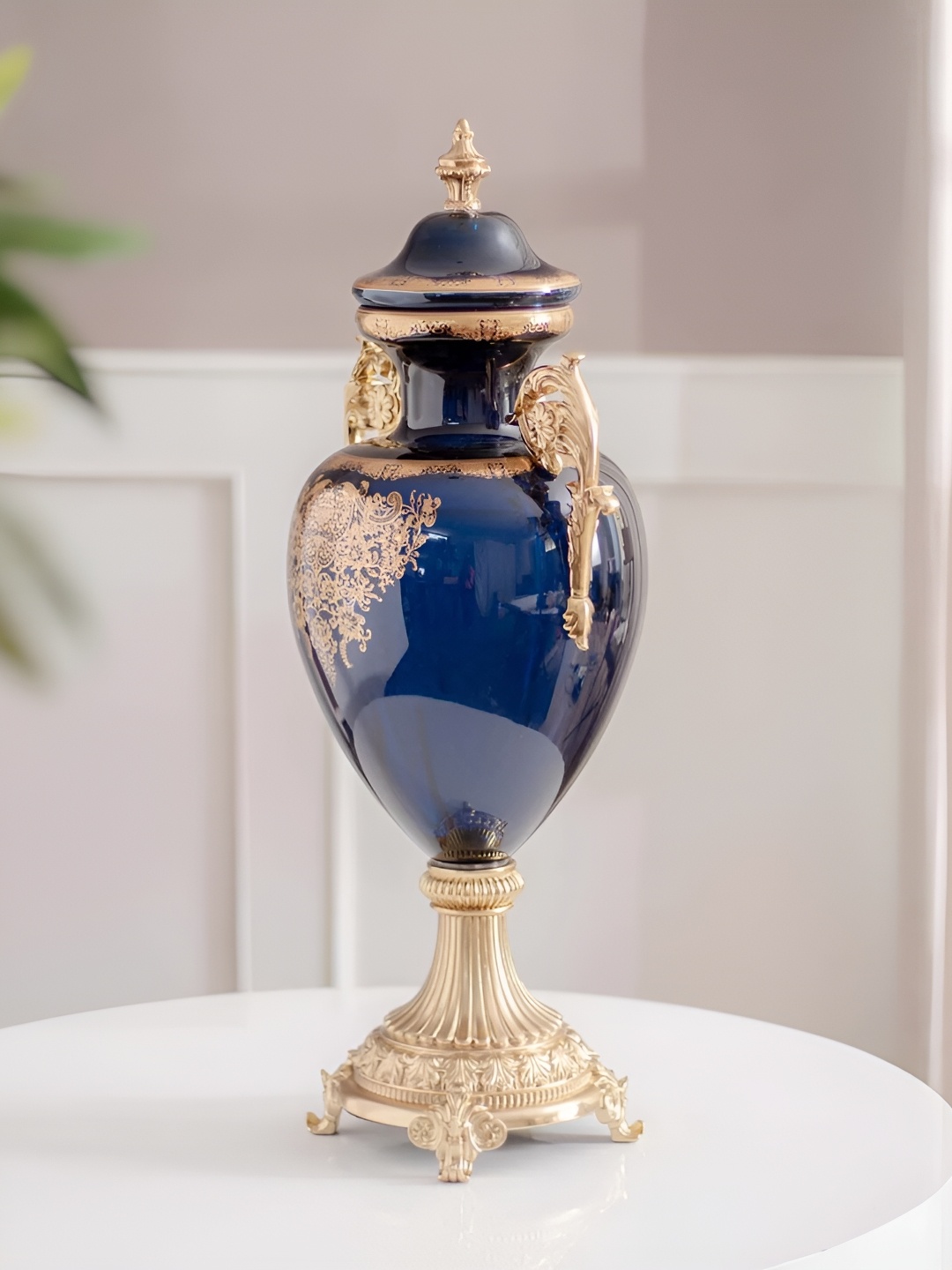 THEDECORKART Navy Blue & Gold Toned Floral Printed Ornate Shape Glass Vase With Lid
THEDECORKART Navy Blue & Gold Toned Floral Printed Ornate Shape Glass Vase With Lid