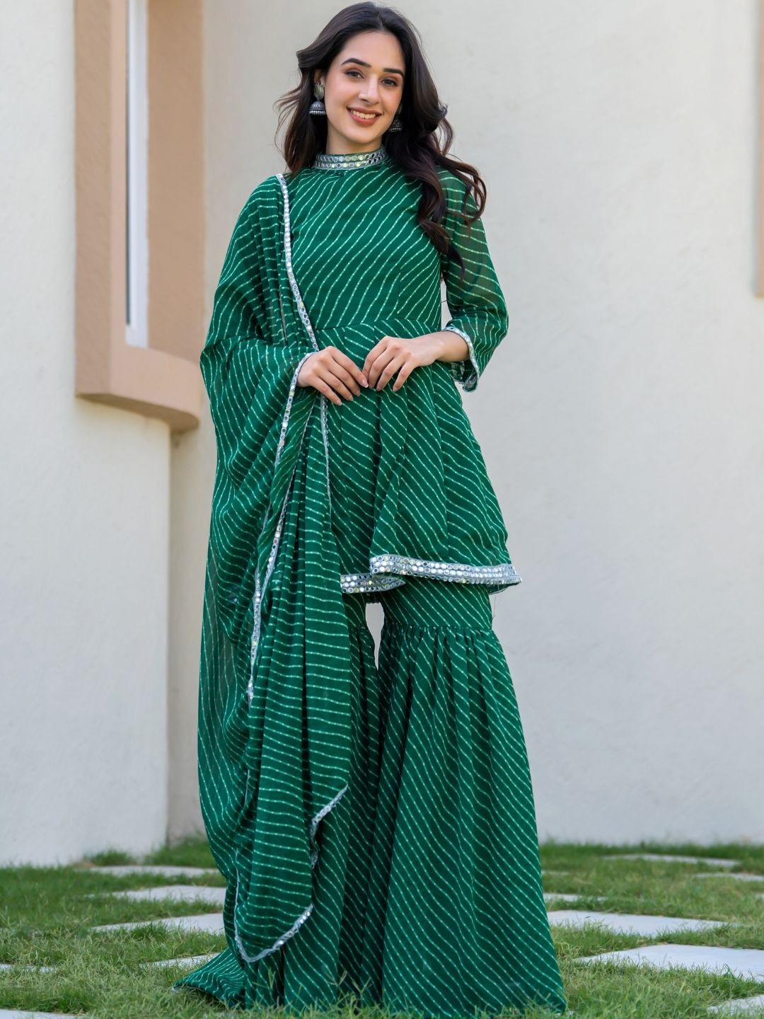 HOUSE OF JAMOTI Leheriya Printed Empire Mirror Work Kurti with Sharara & Dupatta, Green
HOUSE OF JAMOTI Leheriya Printed Empire Mirror Work Kurti with Sharara & Dupatta, Green