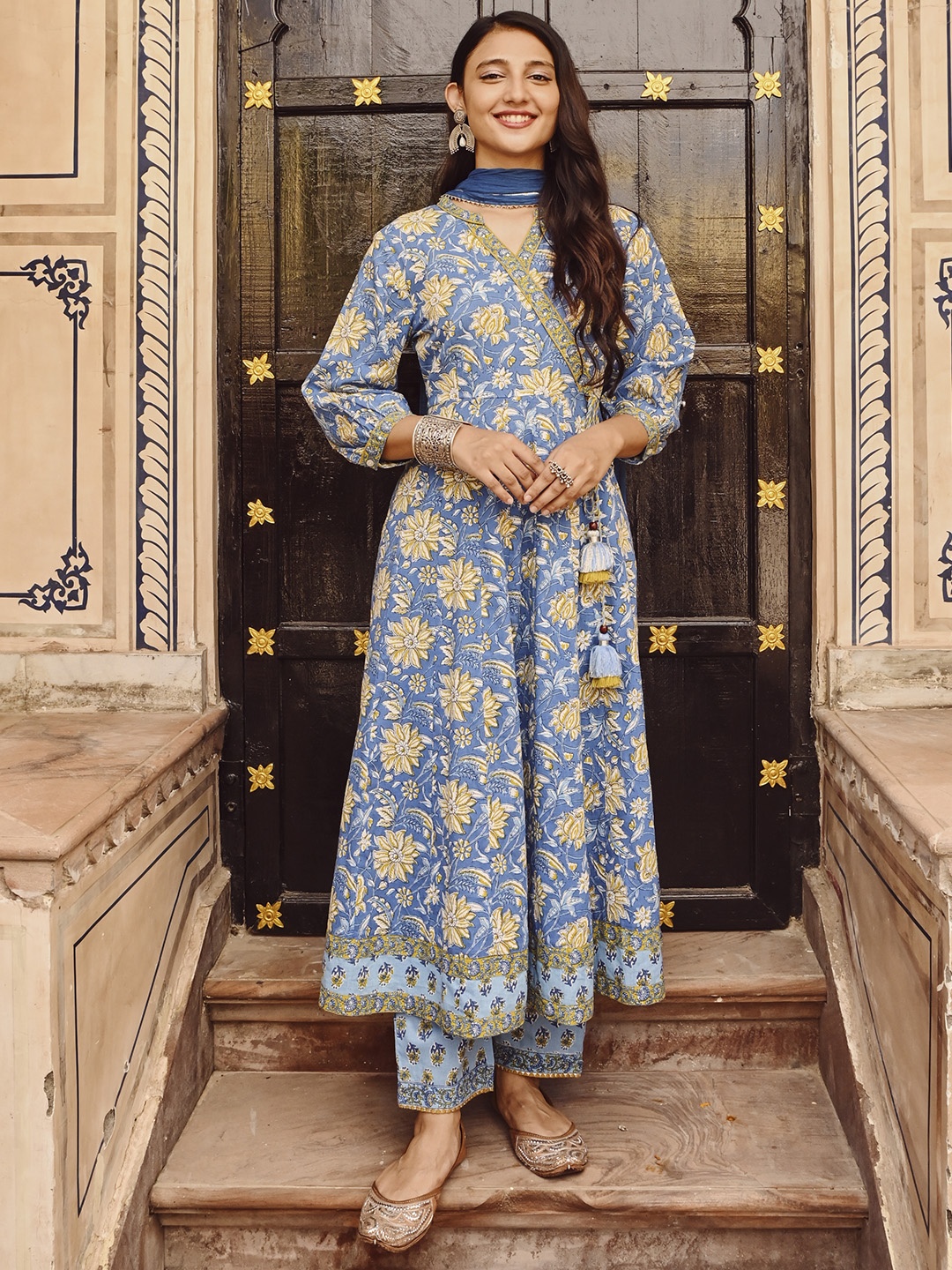 SAVI Women Floral Printed Angrakha Sequinned Pure Cotton Kurta with Trousers & With Dupatta, Blue
SAVI Women Floral Printed Angrakha Sequinned Pure Cotton Kurta with Trousers & With Dupatta, Blue