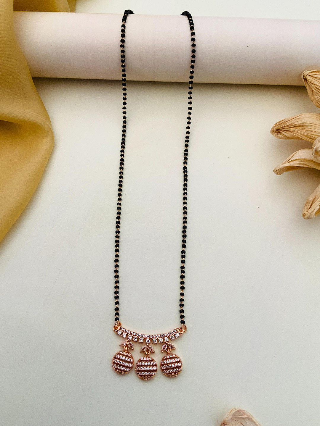 ABDESIGNS Gold-Plated American Diamond Studded and Beaded Mangalsutra, Rose gold
ABDESIGNS Gold-Plated American Diamond Studded and Beaded Mangalsutra, Rose gold