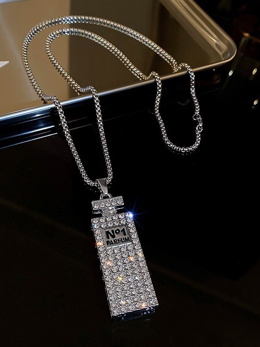 Krelin Men Silver-Plated Rhinestone Studded Perfume Bottle Detail Pendant with Chain
Krelin Men Silver-Plated Rhinestone Studded Perfume Bottle Detail Pendant with Chain
