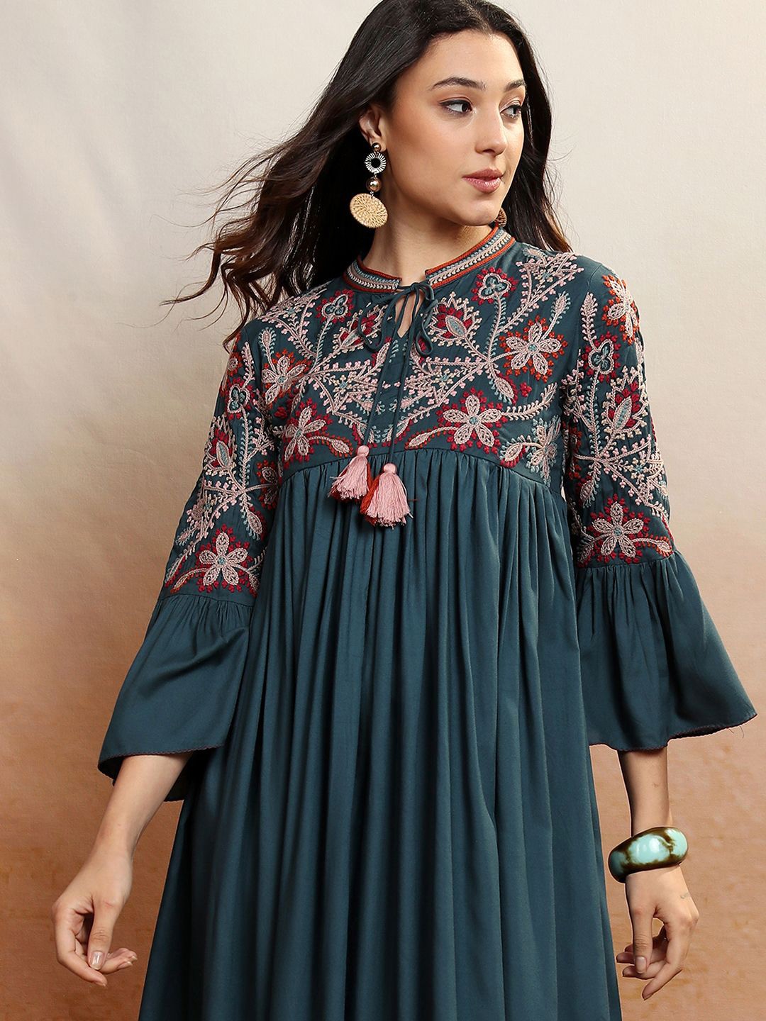 Vishudh Teal Blue Floral Embroidered Tie-Up Neck Bell Sleeves Tiered Midi Ethnic Dress
Vishudh Teal Blue Floral Embroidered Tie-Up Neck Bell Sleeves Tiered Midi Ethnic Dress