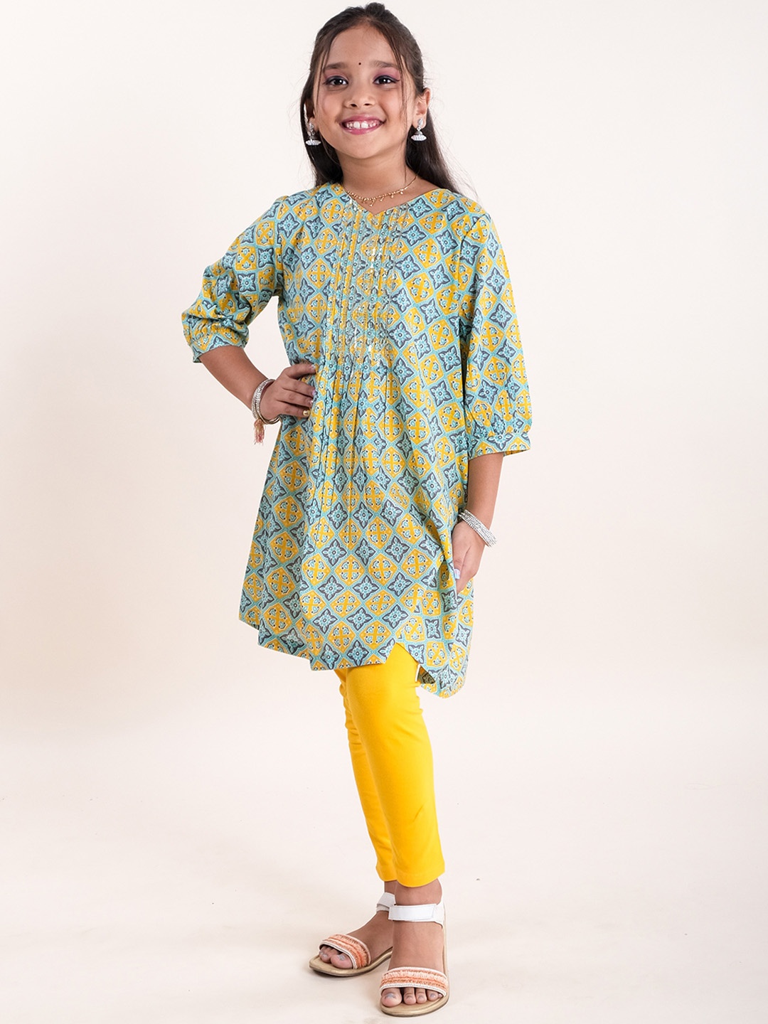 KiddoPanti Girls Round Neck Ethnic Motifs Printed Pleated Pure Cotton Kurta With Leggings, Mustard
KiddoPanti Girls Round Neck Ethnic Motifs Printed Pleated Pure Cotton Kurta With Leggings, Mustard