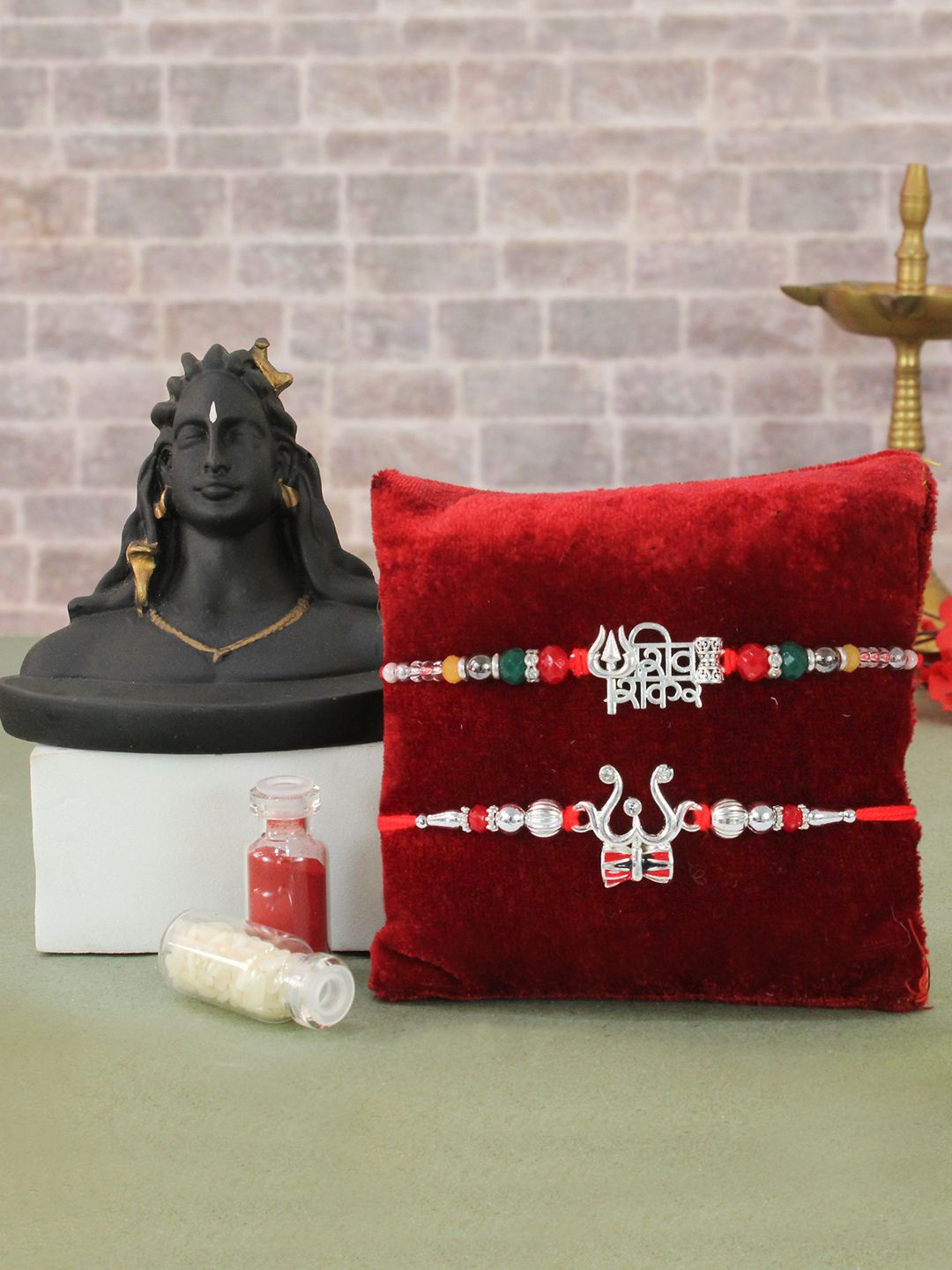 TIED RIBBONS Set Of 2 Trisul Rakhi & Mini Adiyogi Shiva Idol Card Rakhi Gift Set, Red
TIED RIBBONS Set Of 2 Trisul Rakhi & Mini Adiyogi Shiva Idol Card Rakhi Gift Set, Red