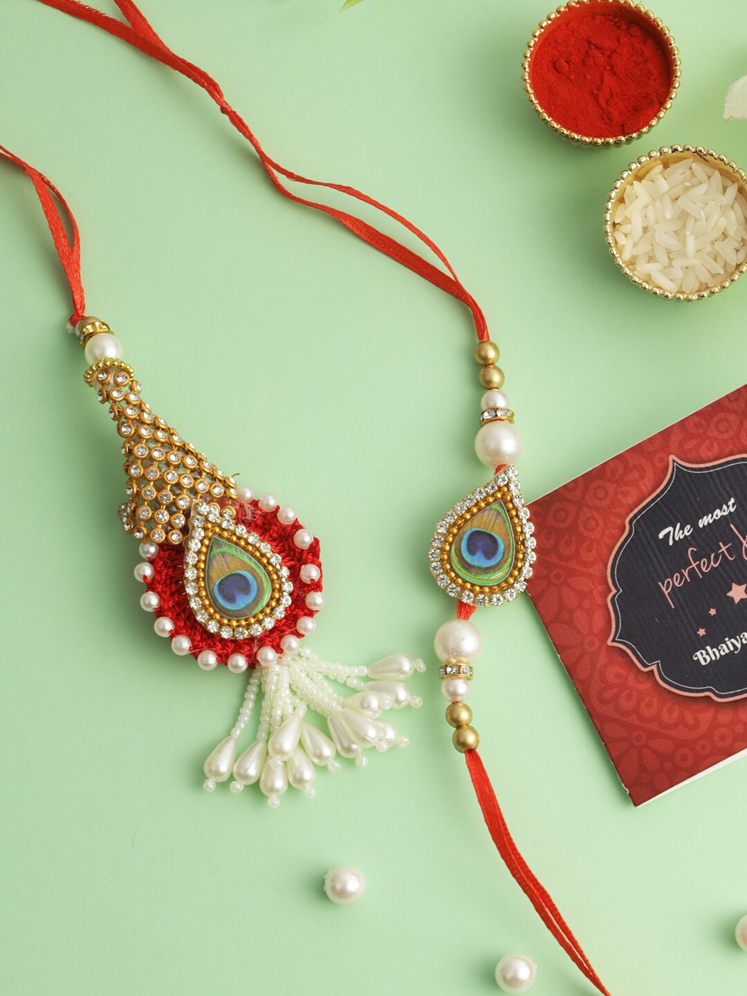 TIED RIBBONS Set of 2 Peacock Rakhi for Bhaiya Bhabhi, Card and Roli Chawal Gift, Red
TIED RIBBONS Set of 2 Peacock Rakhi for Bhaiya Bhabhi, Card and Roli Chawal Gift, Red