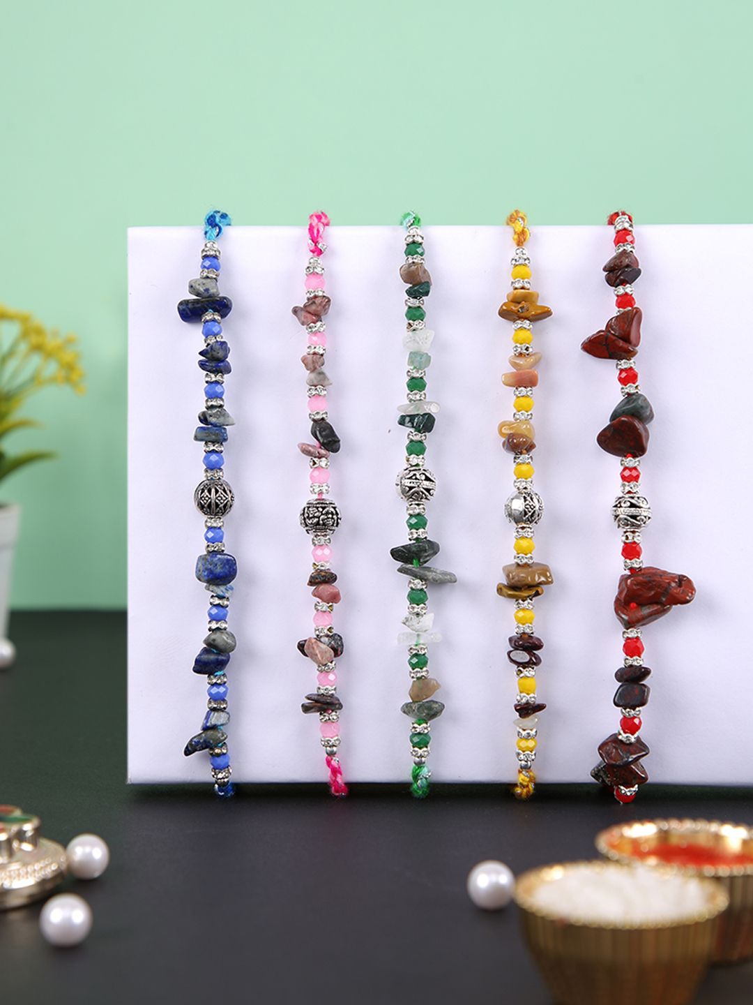 Aapno Rajasthan Set Of 5 Stone Studded & Beaded Rakhis With Roli Chawal & Greeting Card, Brown
Aapno Rajasthan Set Of 5 Stone Studded & Beaded Rakhis With Roli Chawal & Greeting Card, Brown